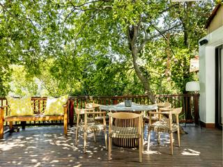 Outer deck area Deborah Garth Interior Design International (Pty)Ltd Other spaces Solid Wood Multicolored Furniture, Table, Chair, Shade, Tree, Building, Wood, Outdoor furniture, Tints and shades, Leisure,yellow,scatters,floor lamp,granite,bench,hemp,rope